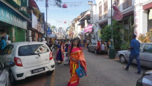 Woman walks on the street due to illegal parking in Penang, Malaysia