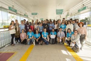 MOBILIZE participants take a group picture in a bus terminal. Bike parking and bike share options have been integrated with bus stations and terminals.