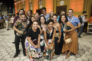 Large group of people, many from Brazil smiling at outdoor reception