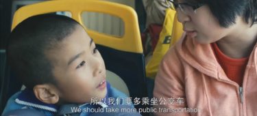 Boy and woman sit next to each other on a Guangzhou BRT bus