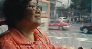 Older woman riding Guangzhou BRT bus